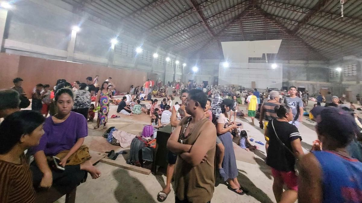 People gather at an evacuation center, in the aftermath of an earthquake, in Hinatuan, Surigao del Sur, Philippines. 