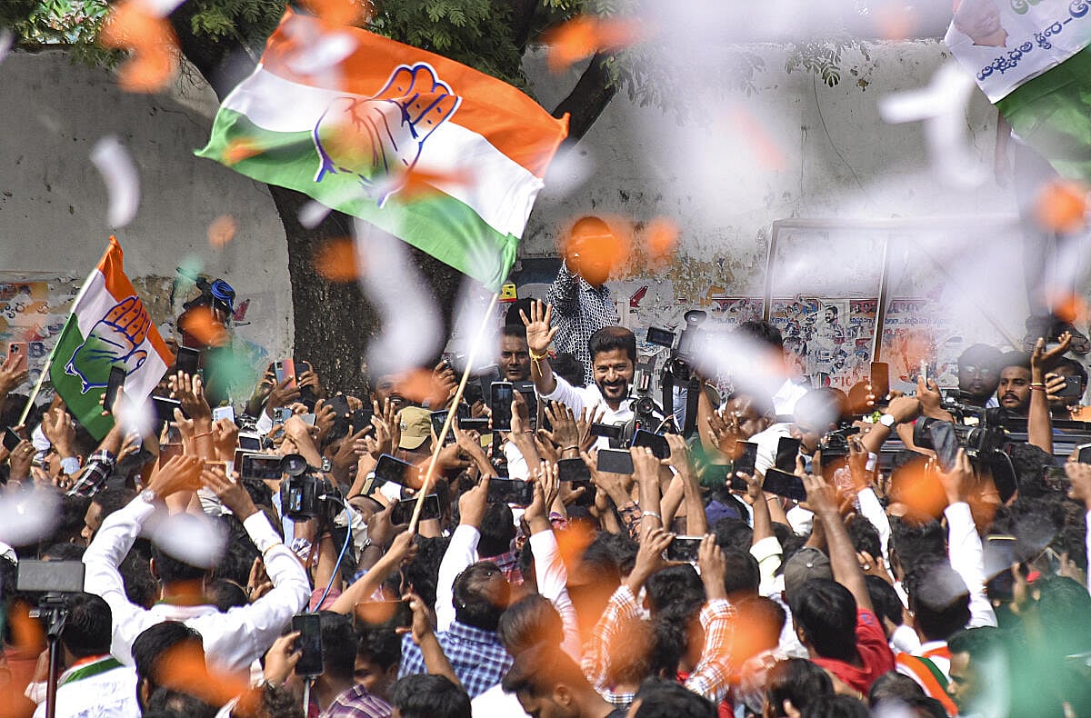 Congress Telangana President A Revanth Reddy greets party workers and supporters celebrating the party's lead during counting of votes for Telangana Assembly elections, in Hyderabad.