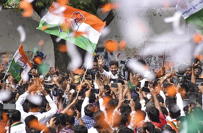 Congress Telangana President A Revanth Reddy greets party workers and supporters celebrating the party's lead during counting of votes for Telangana Assembly elections, in Hyderabad.