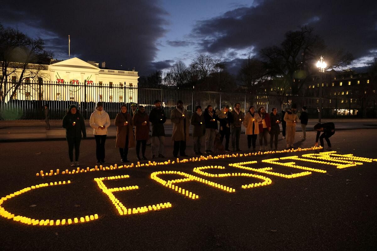 Staff and volunteers of Amnesty International USA, MoveOn, Oxfam America and Win Without War hold a vigil outside the White House calling for a ceasefire in the ongoing conflict between Israel and the Palestinian Islamist group Hamas.