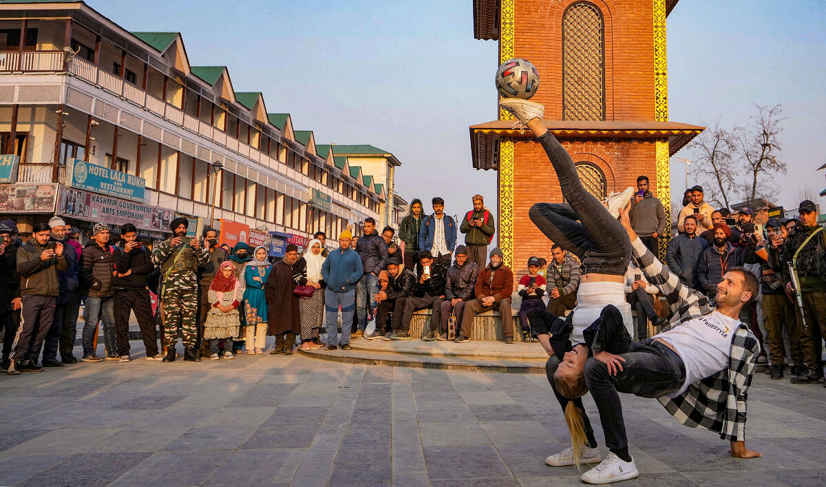 Freestyle football champions Aguska from Poland and Patrick Baurer from Germany, perform at Lal Chowk in Srinagar.