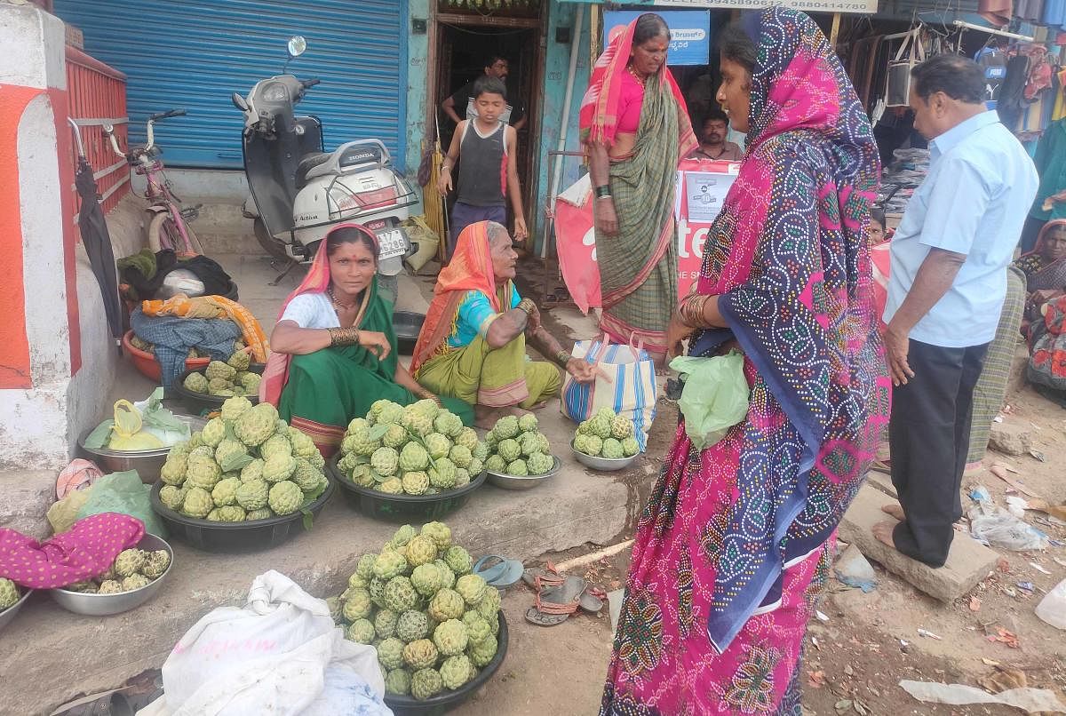 Women sell custard apples grown at their farms in Yadgir district.