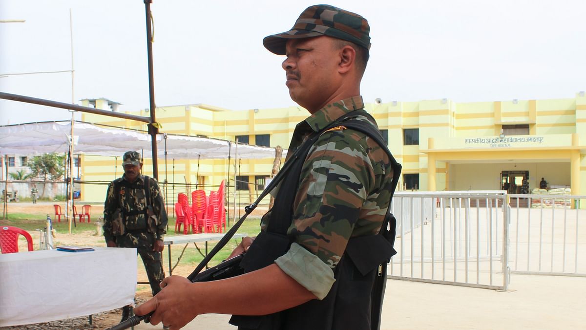 Security personnel outside a strong room where Electronic Voting Machines (EVMs) are kept, a day before the Chhattisgarh Assembly election results, in Jagdalpur. 