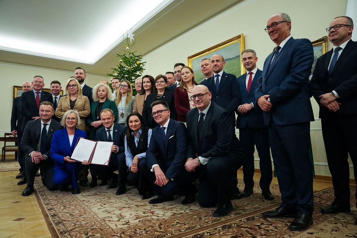 Newly appointed Polish Prime Minister Donald Tusk poses with the members of his government after winning the vote of confidence, in Parliament, in Warsaw.