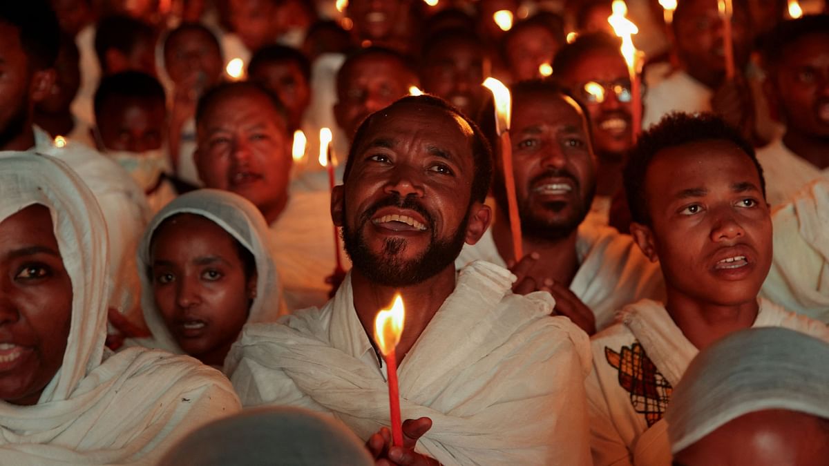 Ethiopian Orthodox faithful hold candles during a Christmas Eve celebration at Bole Medhanialem Church in Addis Ababa, Ethiopia, January 6, 2024.