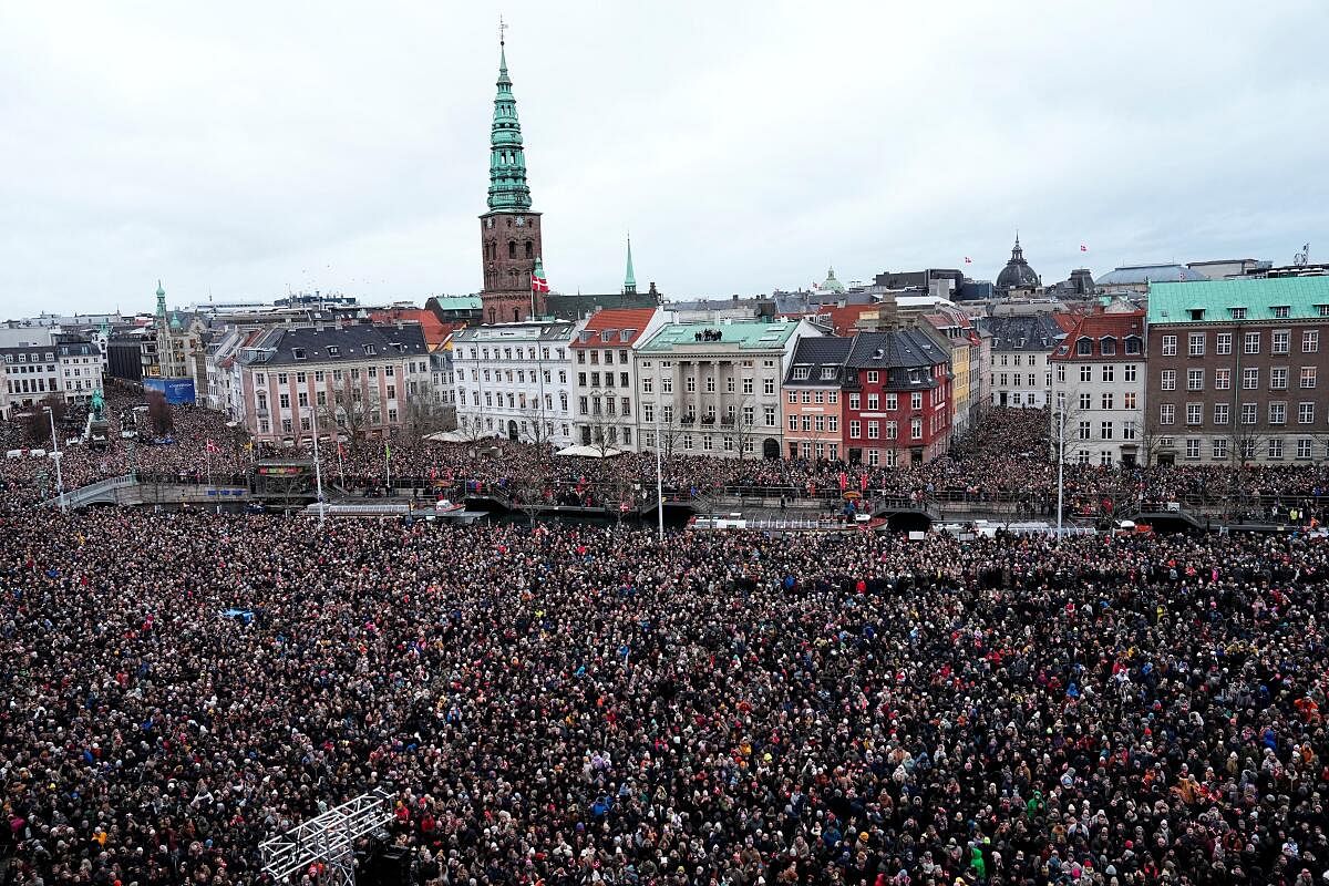 People gather on the day Danish Queen Margrethe abdicates after 52 years on the throne, and her elder son, Crown Prince Frederik, ascends the throne as King Frederik X, in Copenhagen, Denmark, January 14, 2024.