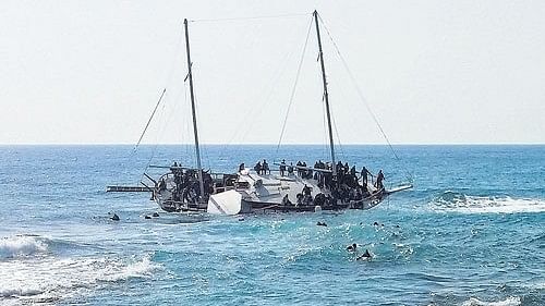 Two migrants found dead, 57 rescued off Greek island