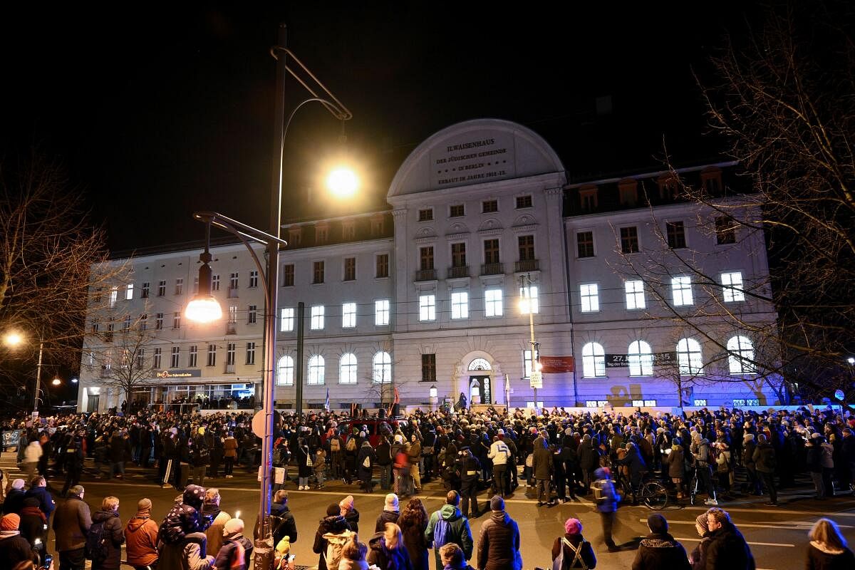 People gather for a chain of lights in front of the Jewish orphanage on the International Holocaust Remembrance Day, in district Pankow, Berlin, Germany.