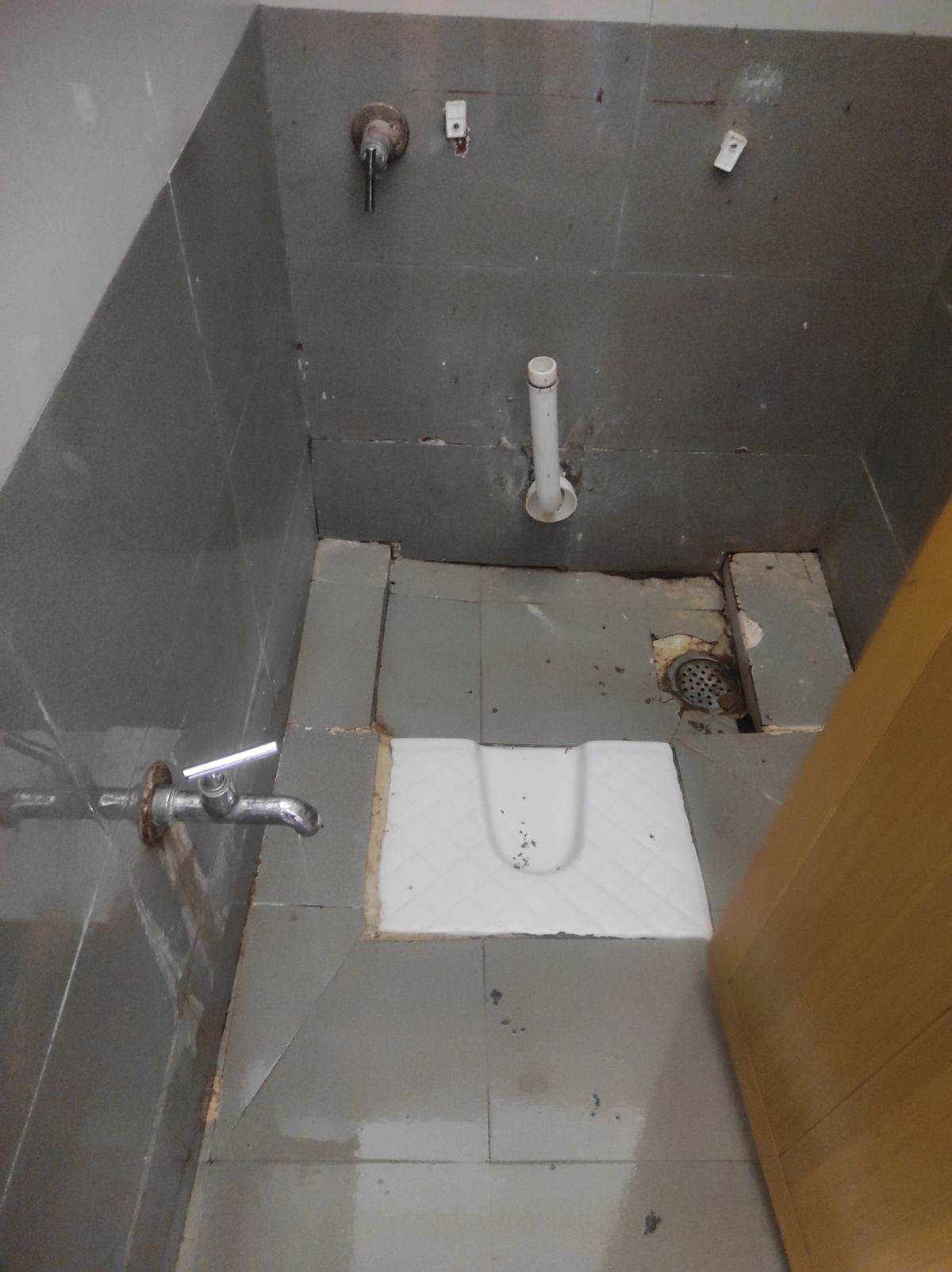A toilet lacking a flush tank at Kalasipalyam TTMC. 