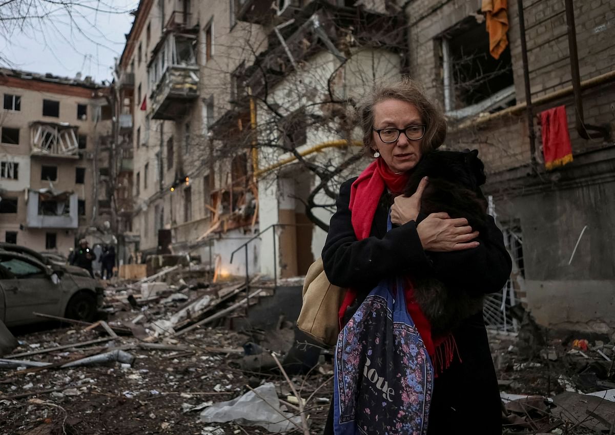 A local resident holding a cat leaves the site where residential buildings were heavily damaged during a Russian missile attack, amid Russia's attack on Ukraine, in central Kharkiv, Ukraine January 2, 2024.