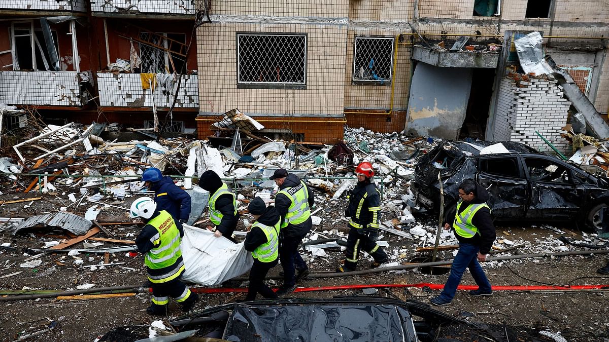 Rescues carry out a body of a person killed during a Russian missile attack, from a heavily damaged apartment building, amid Russia's attack on Ukraine, in Kyiv, Ukraine January 2, 2024. 