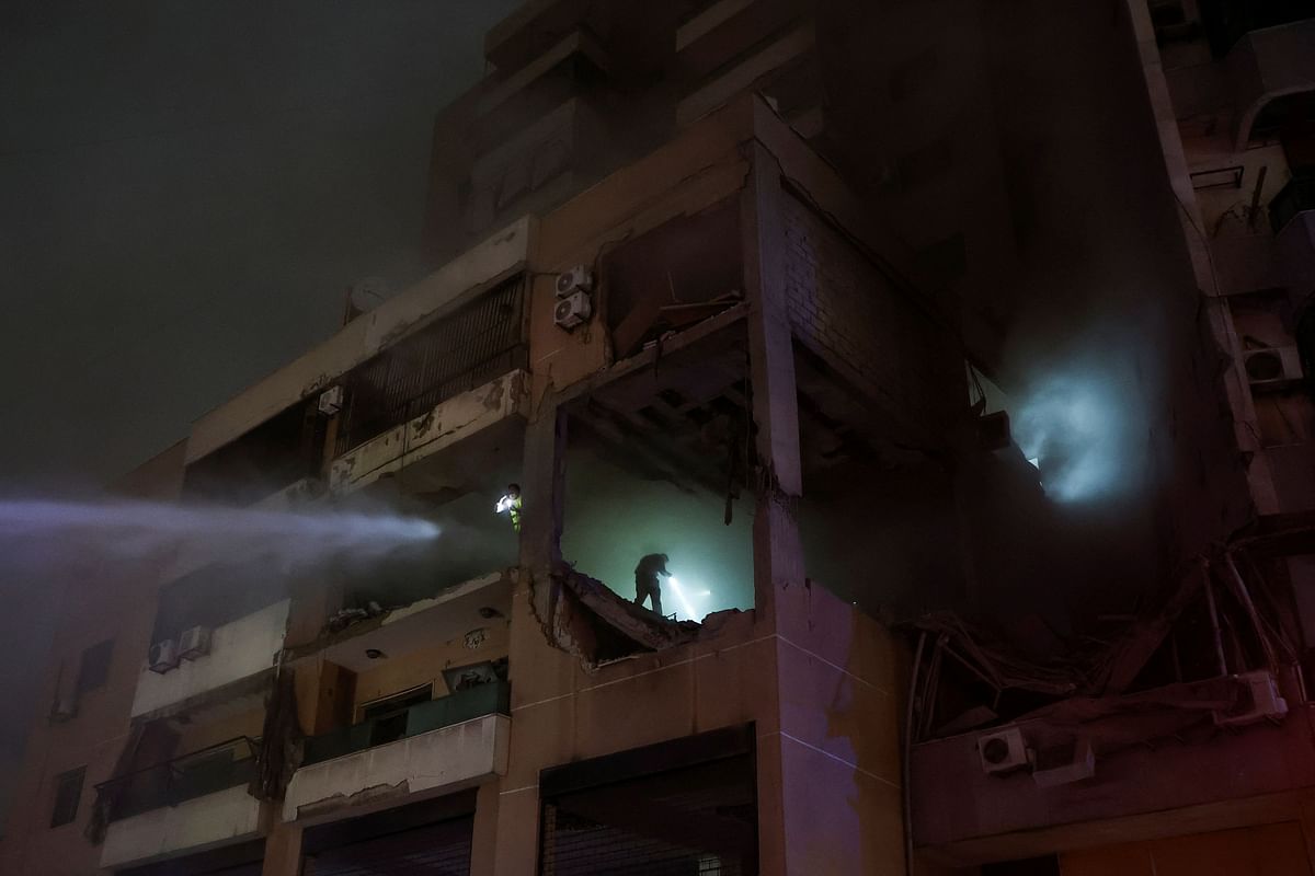 Water is sprayed on a damaged building at the site of an explosion, in what security sources say is an Israeli drone strike, in the Beirut suburb of Dahiyeh, Lebanon January 2, 2024.