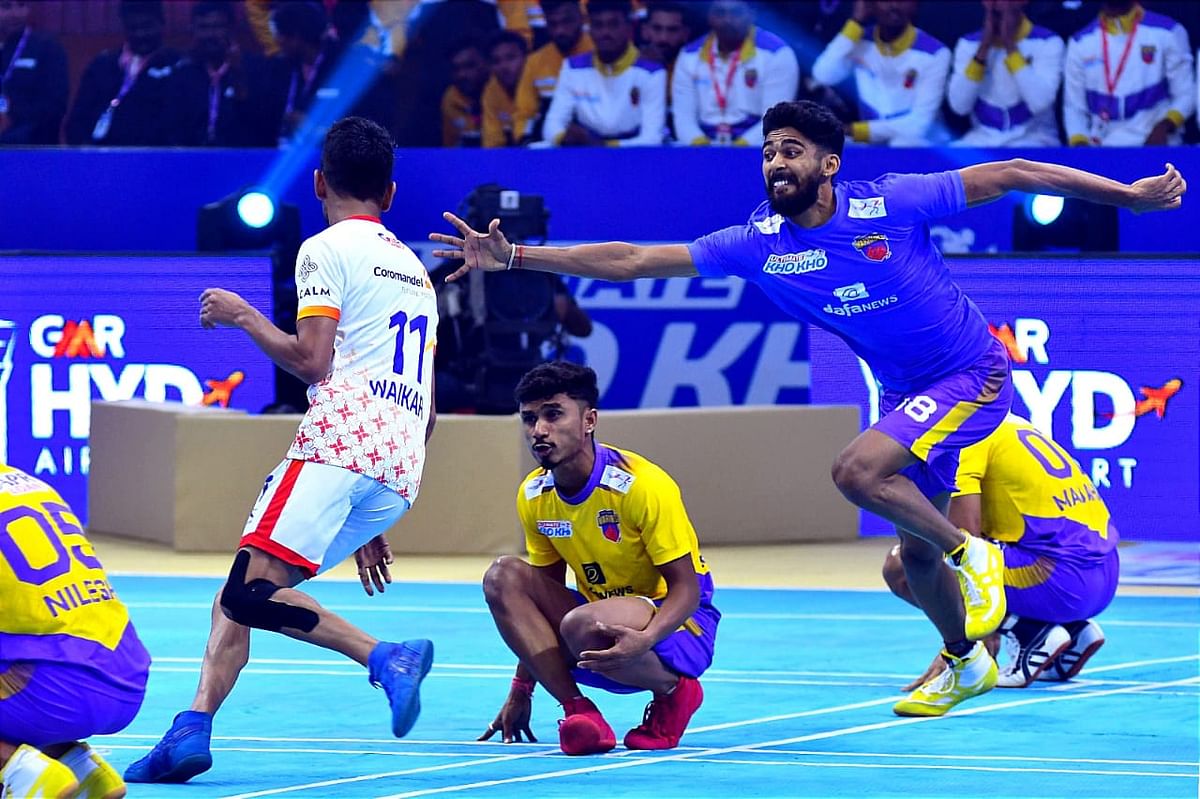 Prajwal (second from right) tries to tag a player during an Ultimate Kho Kho league match