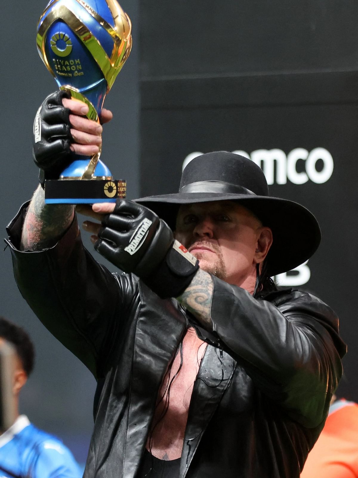 Former professional wrestler The Undertaker holds the Riyadh Season Trophy after the Riyadh Season Cup final match between Al-Nassr and Al-Hilal at the Kingdom Arena in Riyadh.