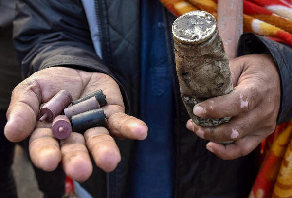  A farmer shows a tear gas shell and rubber bullets fired by the police to disperse protesting farmers gathered at the Punjab-Haryana Shambhu border during their Dilli Chalo' march.