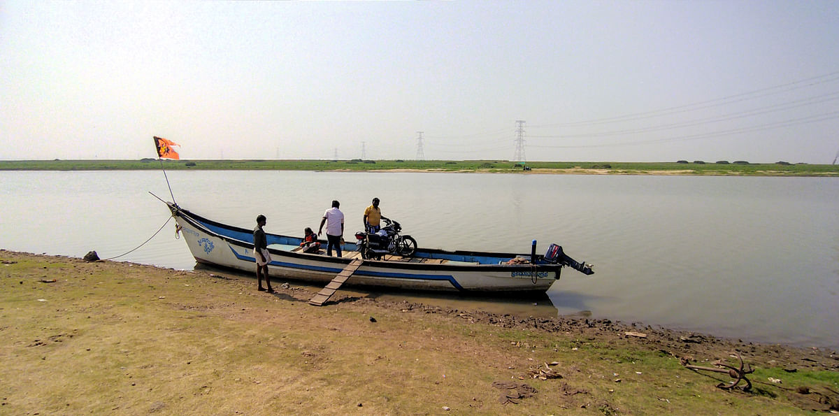 A ferry transports people to areas after water levels of the Tungabhadra recede. 