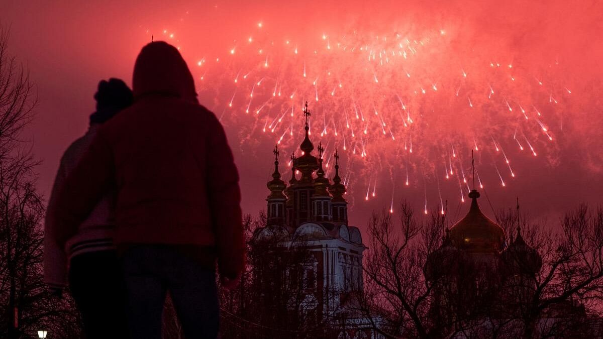 Fireworks explode behind the Novodevichy monastery amid Defender of the Fatherland Day celebrations, in Moscow.