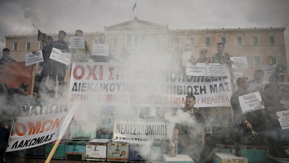 Greek beekeepers stack hives in front of parliament in protest.
