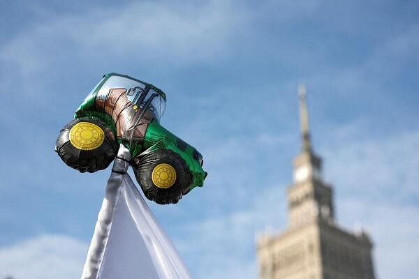 A tractor balloon sits atop a flagpole, as Polish farmers protest over price pressures, taxes and green regulation, grievances shared by farmers across Europe and against the import of agricultural produce and food products from Ukraine, near the Palace of Culture and Science in Warsaw, Poland, February 27.