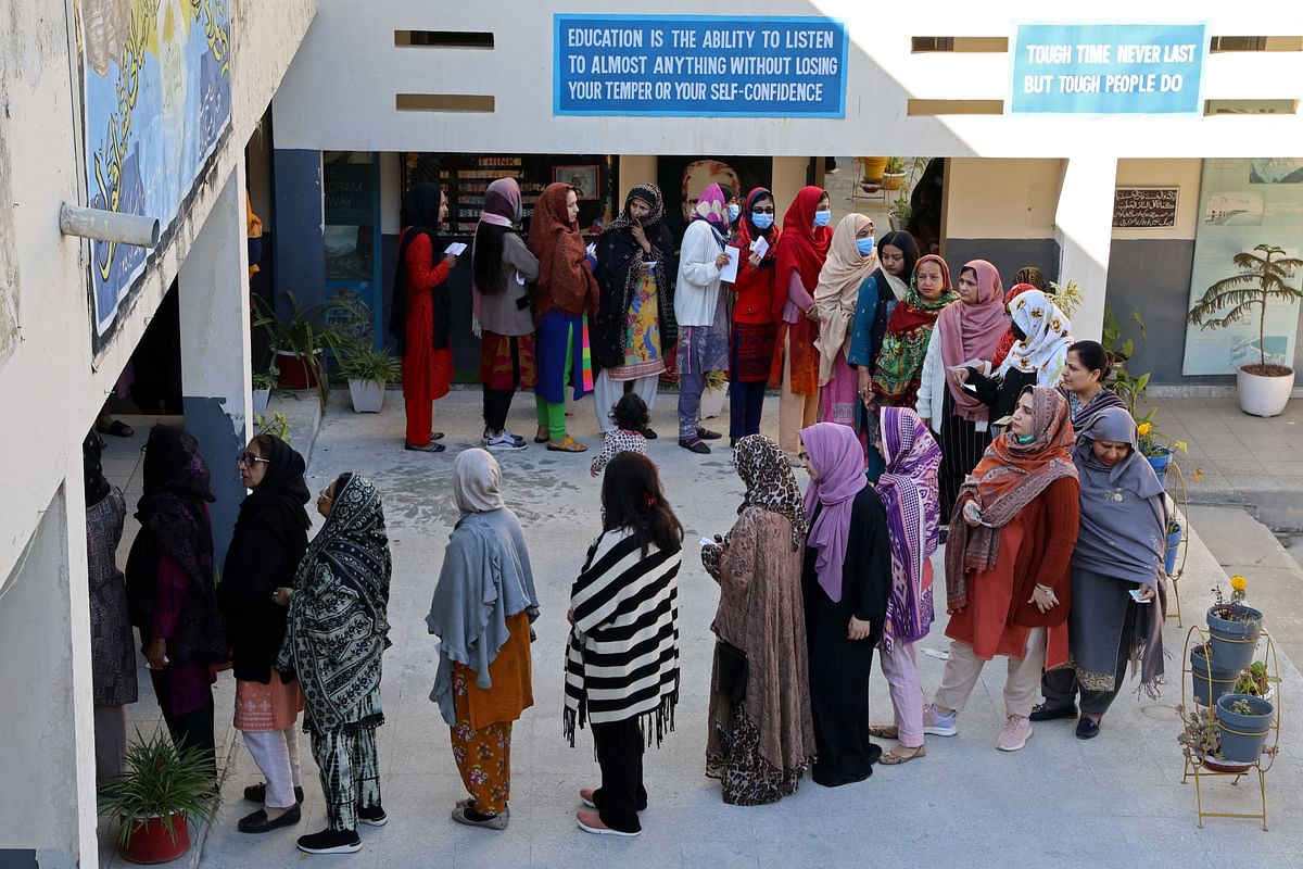 Voters queue to vote at a polling station in a school during a general election, in Islamabad, Pakistan February 8, 2024.