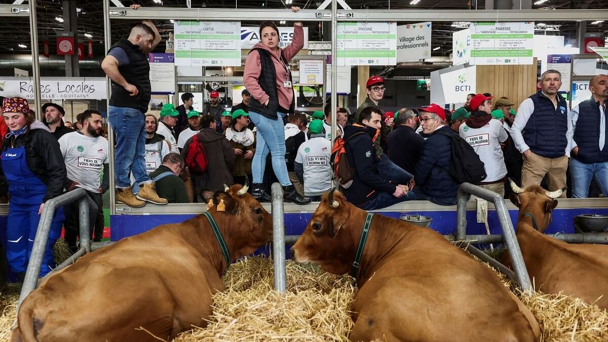 Angry French farmers storm into Paris agriculture fair ahead of President Macron's visit