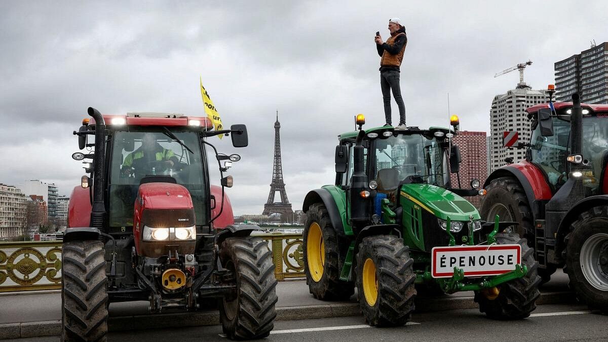Farmers protest ahead of the opening of the Paris farm show, in Paris.