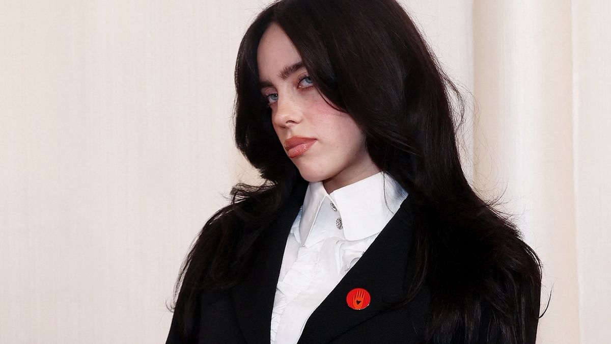 Billie Eilish gets clicked arriving at the Oscar 2024 red carpet donning the red pin.