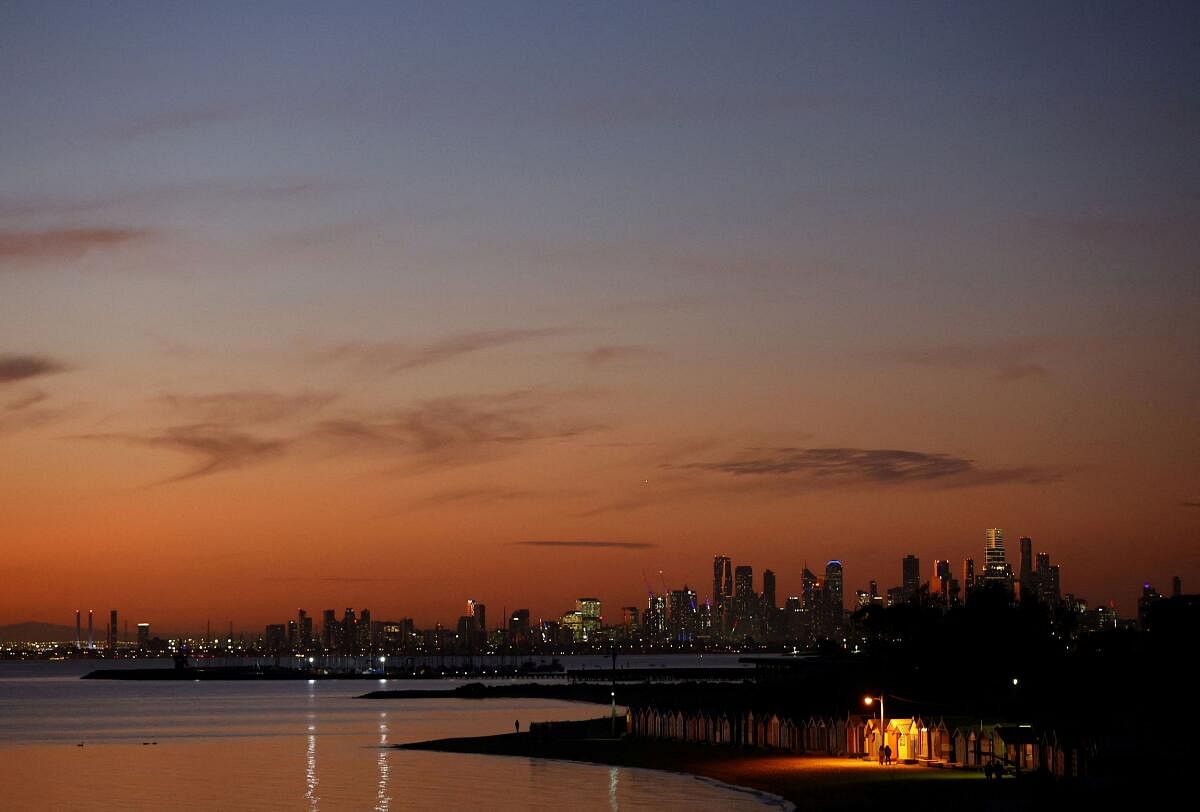 A view of Brighton Beach in front of the Melbourne skyline during sunset in Melbourne, Australia.