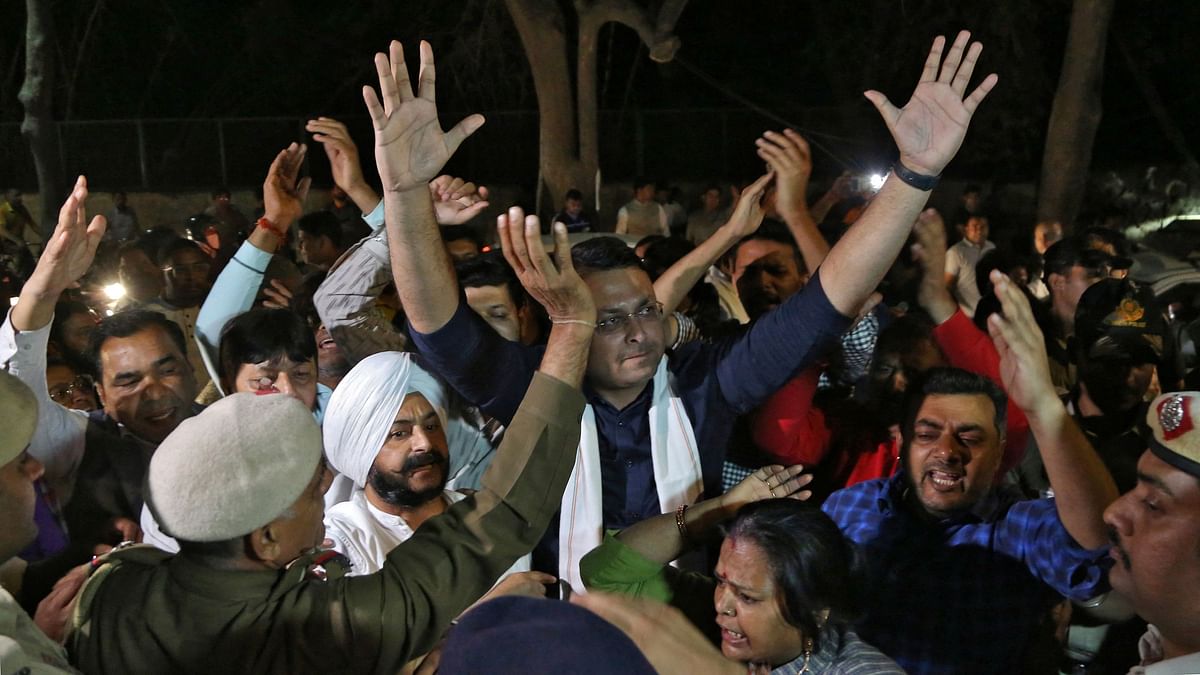 Supporters of the Aam Aadmi Party (AAP) shout slogans outside Kejriwal's residence after his arrest.