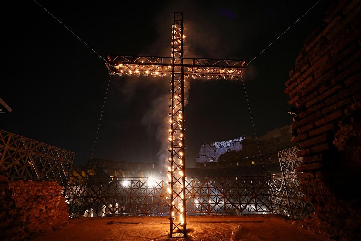 A view of an illuminated cross inside the Colosseum, on the day Pope Francis presides over the Via Crucis (Way of the Cross) procession during Good Friday celebrations, in Rome.