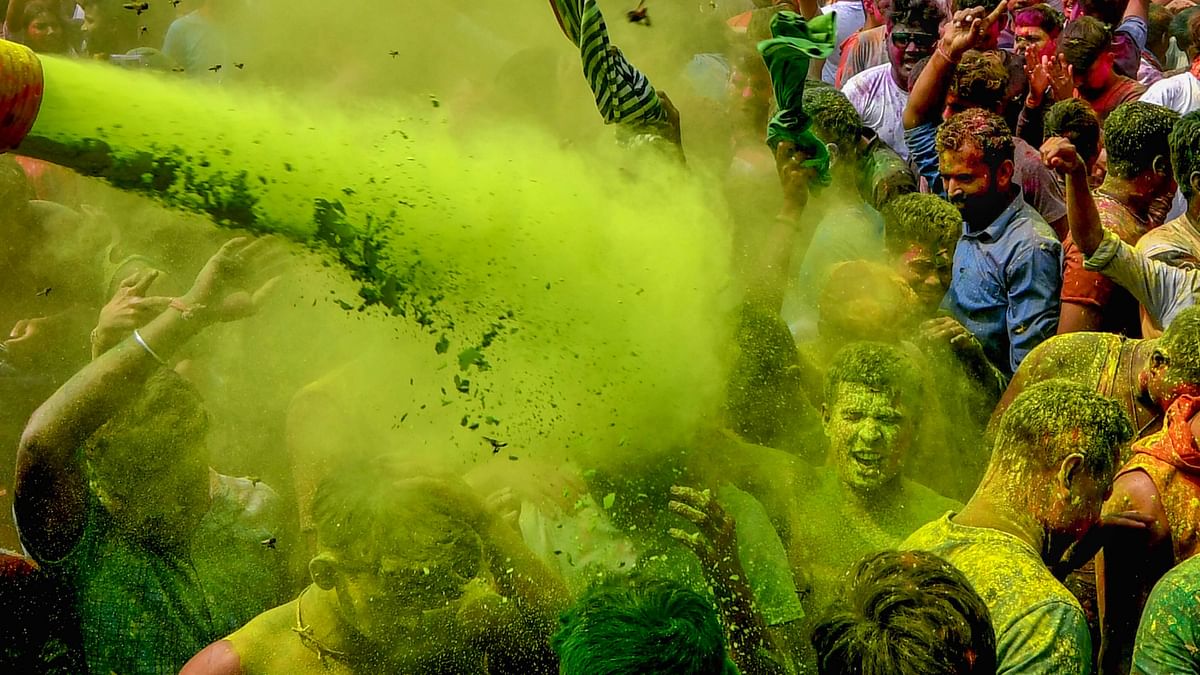 People play with colours during Holi festival celebrations, in Guwahati.