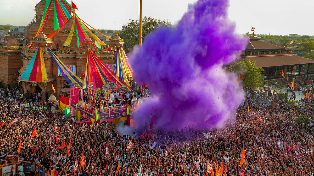 People play with colour during Holi festival celebrations at a temple, in Sarangpur, Gujarat.