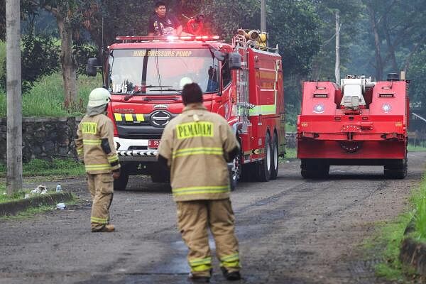 A firefighting robot passes after a massive fire broke out at a military ammunition facility in Bogor.