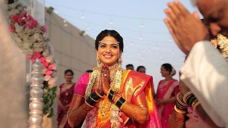 The bride looked radiant in an orange saree which shimmered with its own ethereal glow.