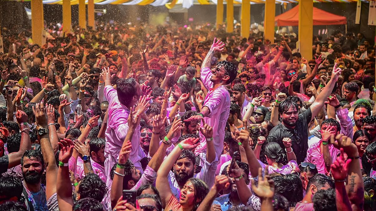 People play with colours and dance during Holi festival celebrations, in Navi Mumbai.