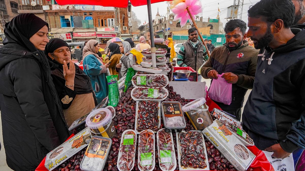People buy dates and other dry fruits ahead of the holy month of Ramadan, at a market in Srinagar.