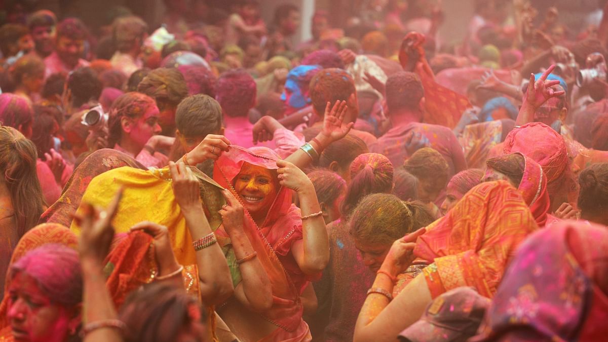 People play with colours during Holi festival celebrations, in Hyderabad.