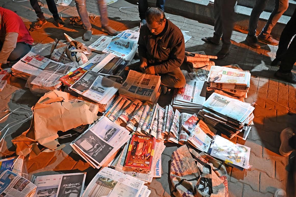 Hawkers organise copies of newspapers