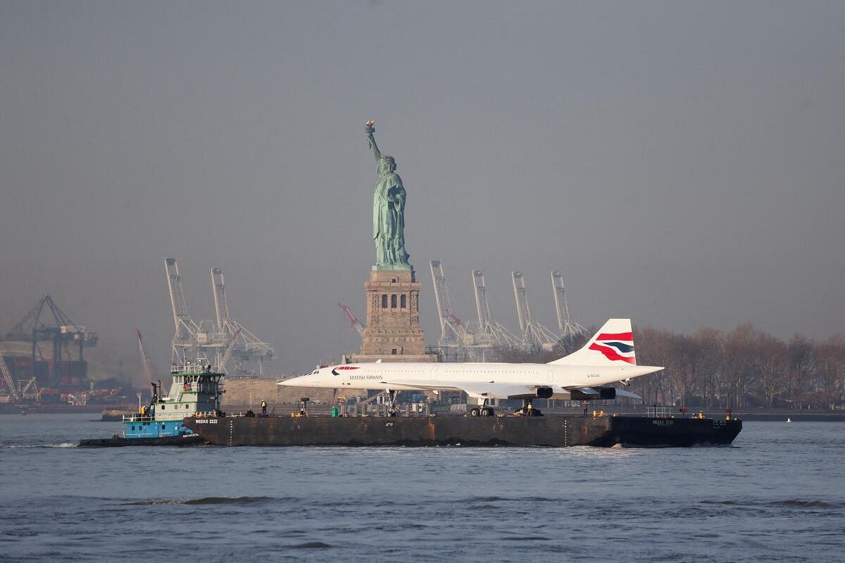 The Concorde super sonic jet is carried on a barge along the Hudson River past the Statue of Liberty returning to the Intrepid Sea, Air and Space museum in New York, U.S., March 14, 2024.