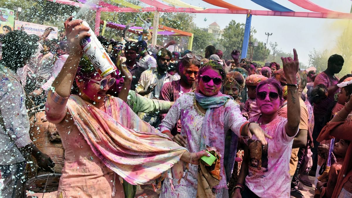 People play with colours during Holi festival celebrations, at Khatu Shyam temple in Lucknow.