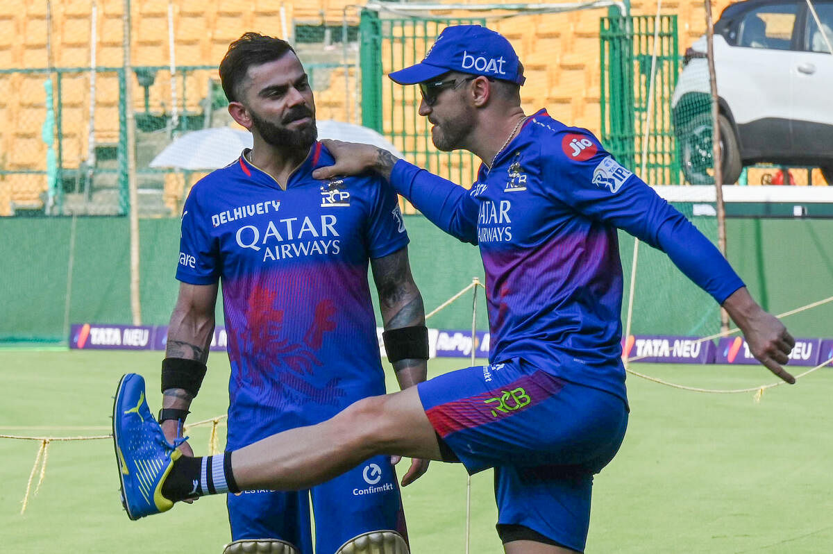 Faf du Plessis and Virat Kohil share a lighter moment during an RCB practice in Bengaluru.
