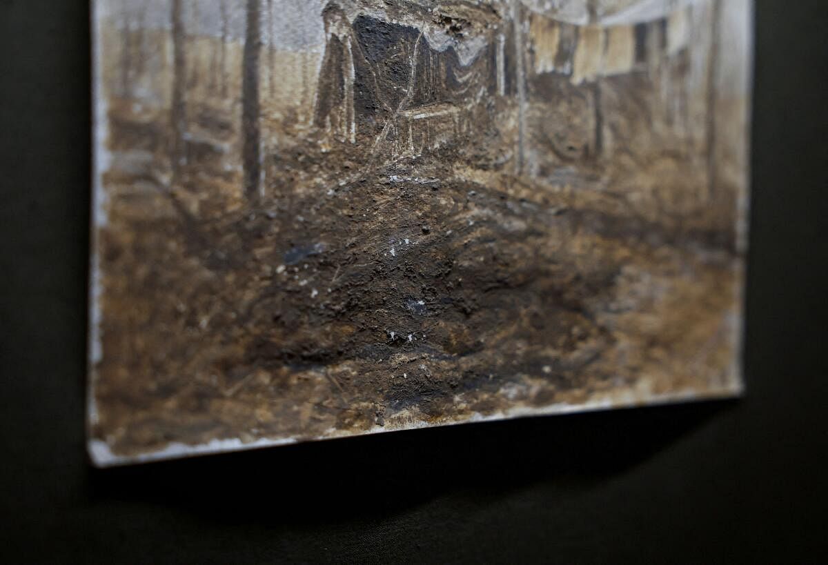 Trench mud is visible on a fragment of a painting displayed at the exhibition of a Ukrainian serviceman Oleg Bazylewicz, 59, who draws pictures with mud, clay and ashes from a frontline, amid Russia's attack on Ukraine, in Kyiv, Ukraine March 11, 2024.