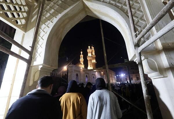 People walk to the gate after breaking their fast, during the holy fasting month of Ramadan in front of Al-Azhar mosque, in Cairo.