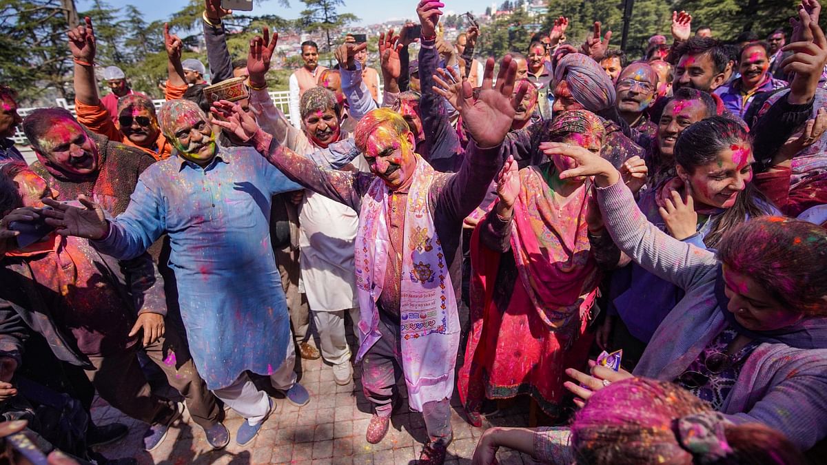 Himachal Pradesh Chief Minister Sukhvinder Singh Sukhu dances with his supporters during Holi celebrations at his Shimla residence.