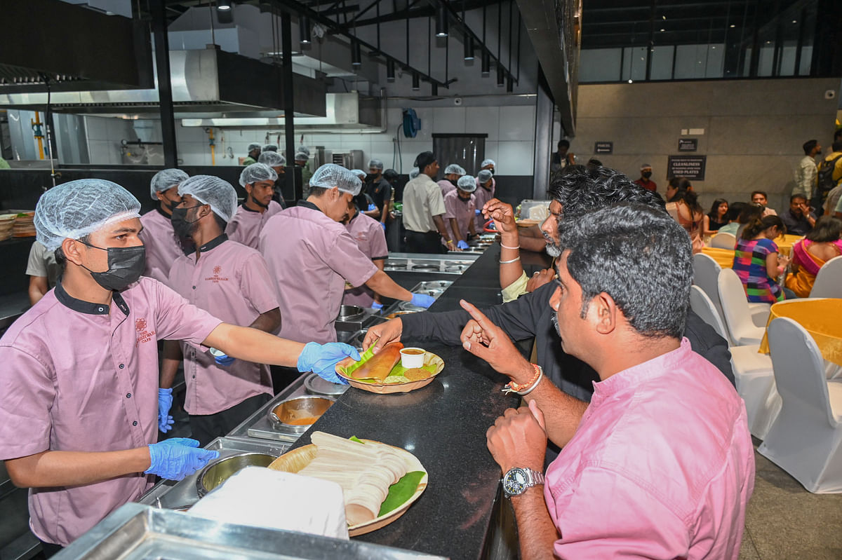 People enjoying workers distributing food after the reopening of The Rameshwaram Café Green Avenue Plot 1 ITPL Main Rd EPIP Zone Brooke field in Bengaluru on Friday 08th March 2024. 