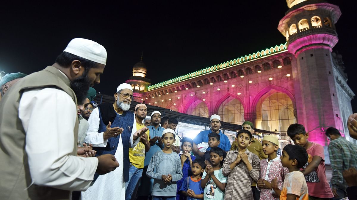 Muslims offer prayers after the crescent moon was sighted in India, in Hyderabad.