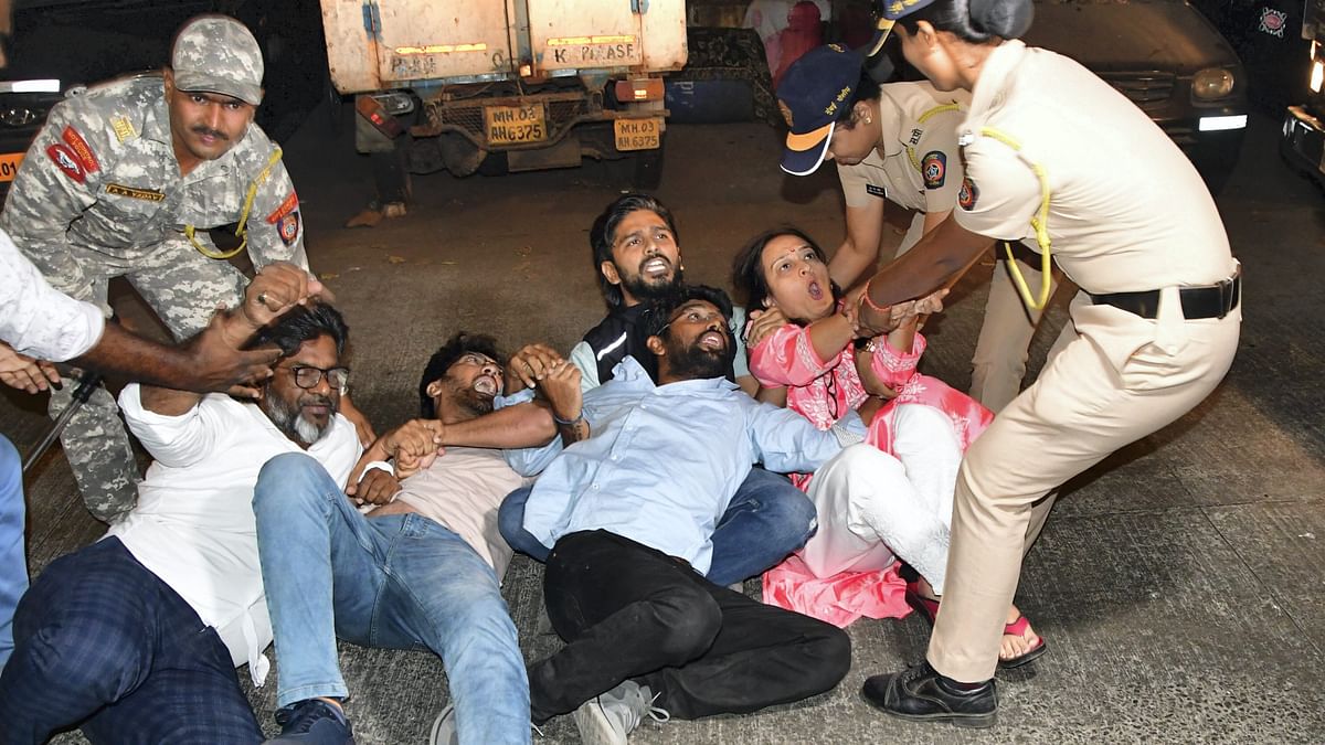 Police detain AAP volunteers during a protest against the arrest of Delhi Chief Minister Arvind Kejriwal in Mumbai.