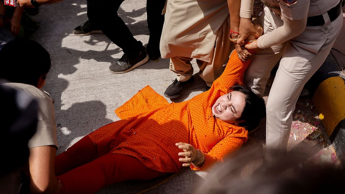 Police detain a supporter of the Aam Aadmi Party  during a protest in Delhi.