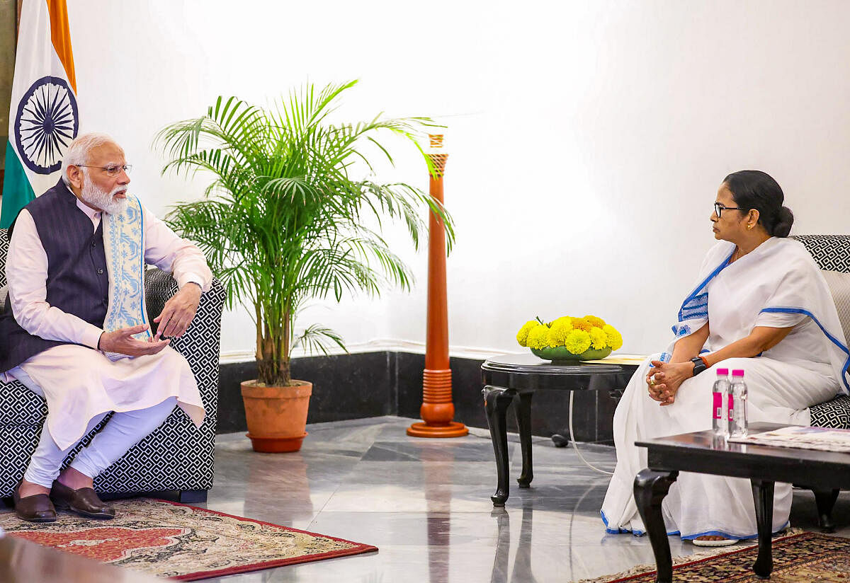 Prime Minister Narendra Modi with West Bengal Chief Minister Mamata Banerjee during a meeting, in Kolkata.