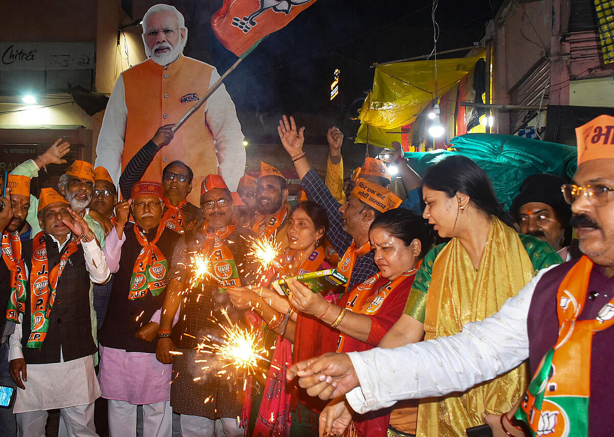 BJP workers celebrate the announcement of Prime Minister Narendra Modi contesting from Varanasi for the third time after BJP released its first list of candidates for the upcoming Lok Sabha elections, in Varanasi.